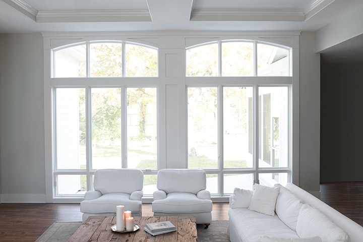 Modern minimalist living room with large windows and contemporary gray furniture