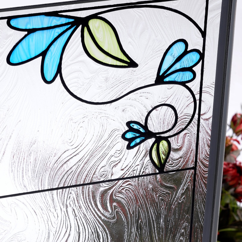Stained glass window art with blue flowers and botanical leaf designs on textured background
