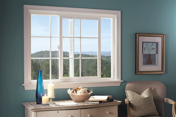 Serene interior room with mountain view through large windows and tasteful home furnishings