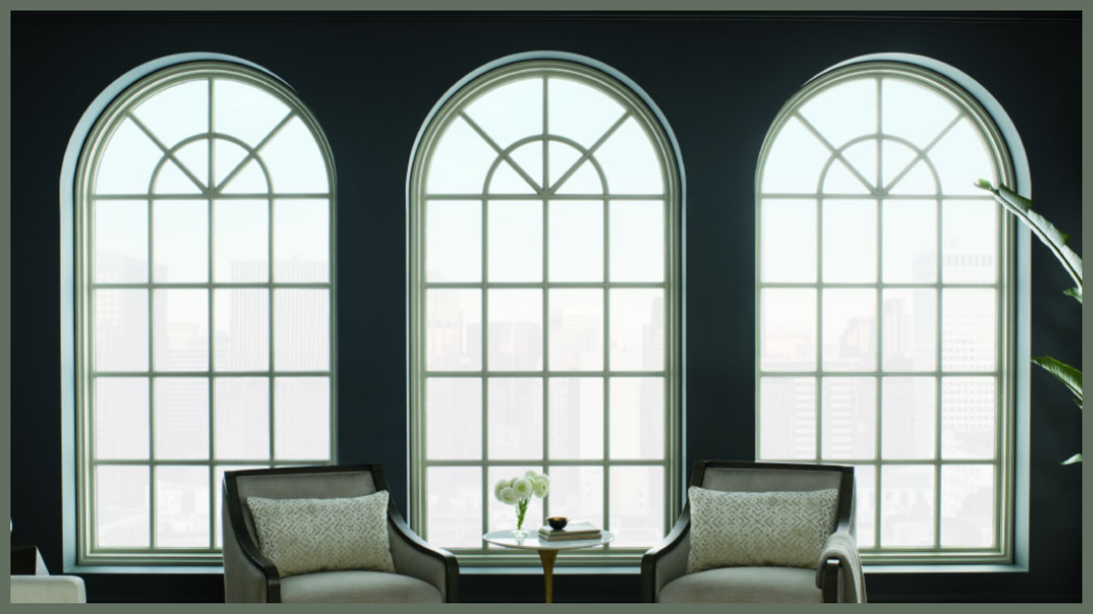 Elegant lounge with three arched windows, chairs, and natural light in modern interior